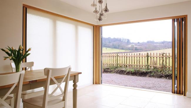 Two joining 205 Integrated Folding Doors with built-in light-filtering shade