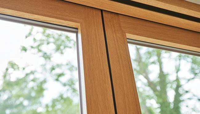 Folding door hinge is hidden from sight within the edge of the door